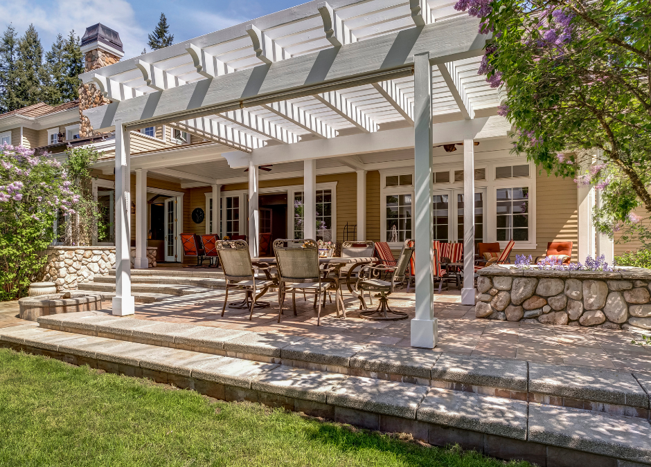 A brick deck and white pergola